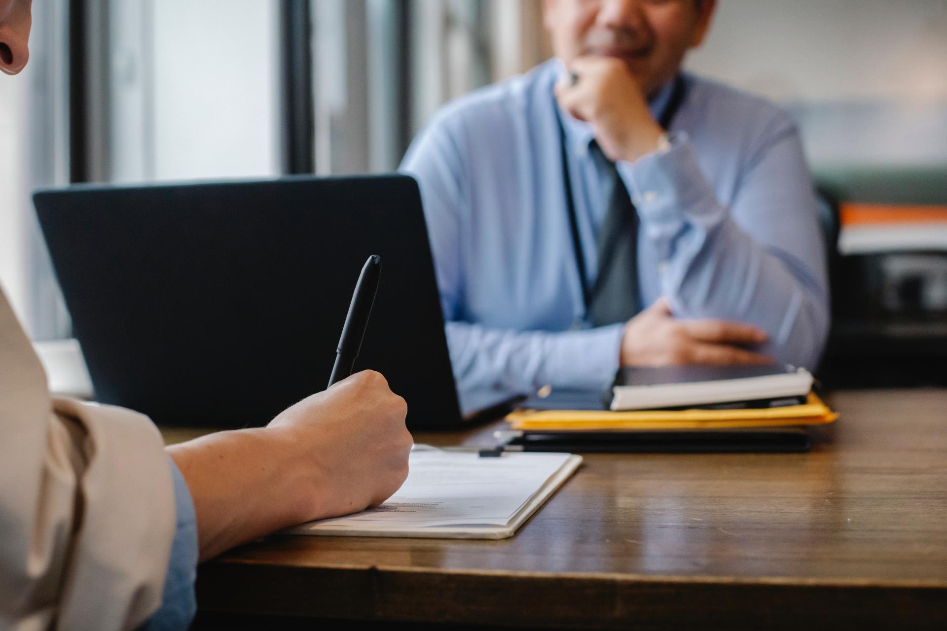 Woman taking notes during meeting